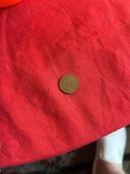 Unknown (based on color and general size, it appears to be a US Cent, possibly a Lincoln Cent)